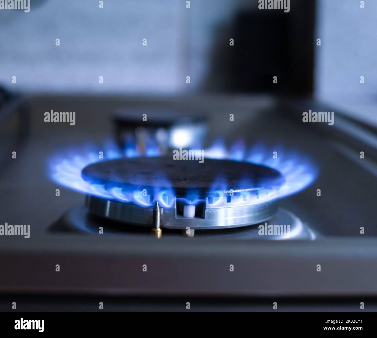 Close-up of a blue fire from a kitchen stove. Gas burner with a burning flame. economy concept Stock Photo