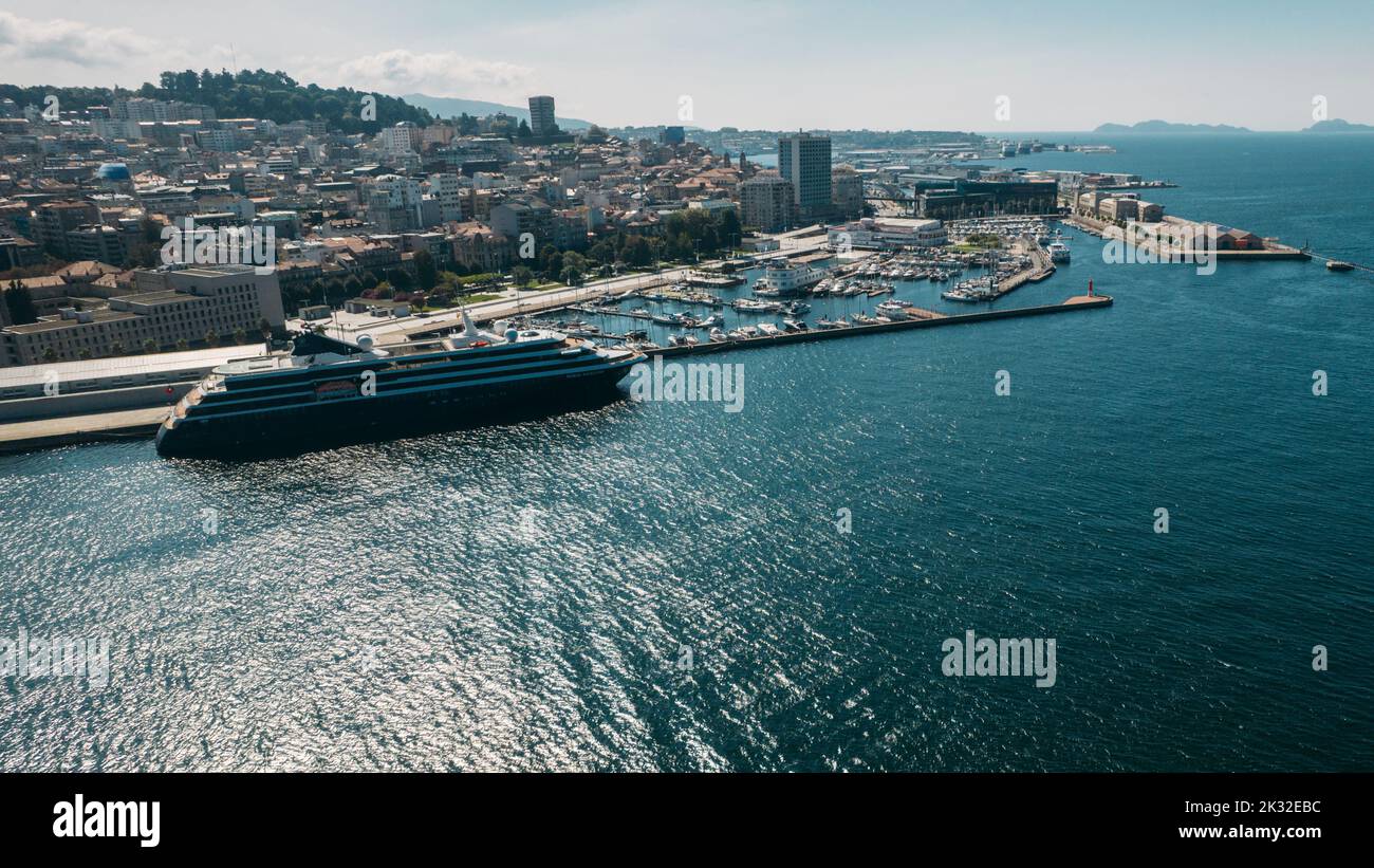 Vigo, Spain - September 23, 2022: Aerial drone view of cruise ship, marina and view of centre of Vigo, Galicia, Spain Stock Photo