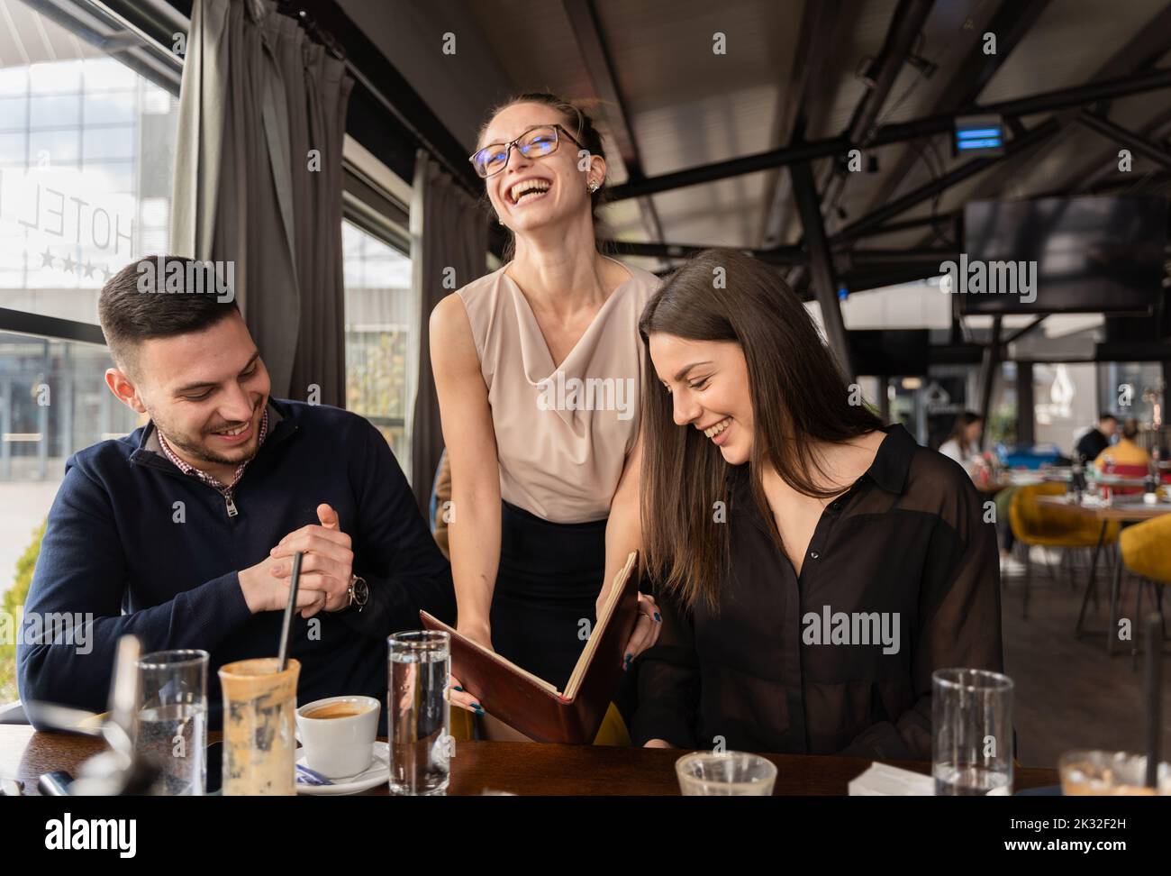 Attractive and beautiful boss lady is showing them something and ...