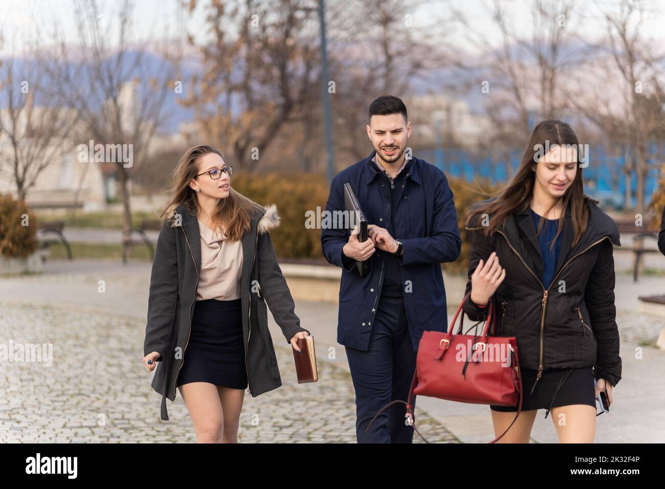 Group of young business people are walking and talking Stock Photo - Alamy