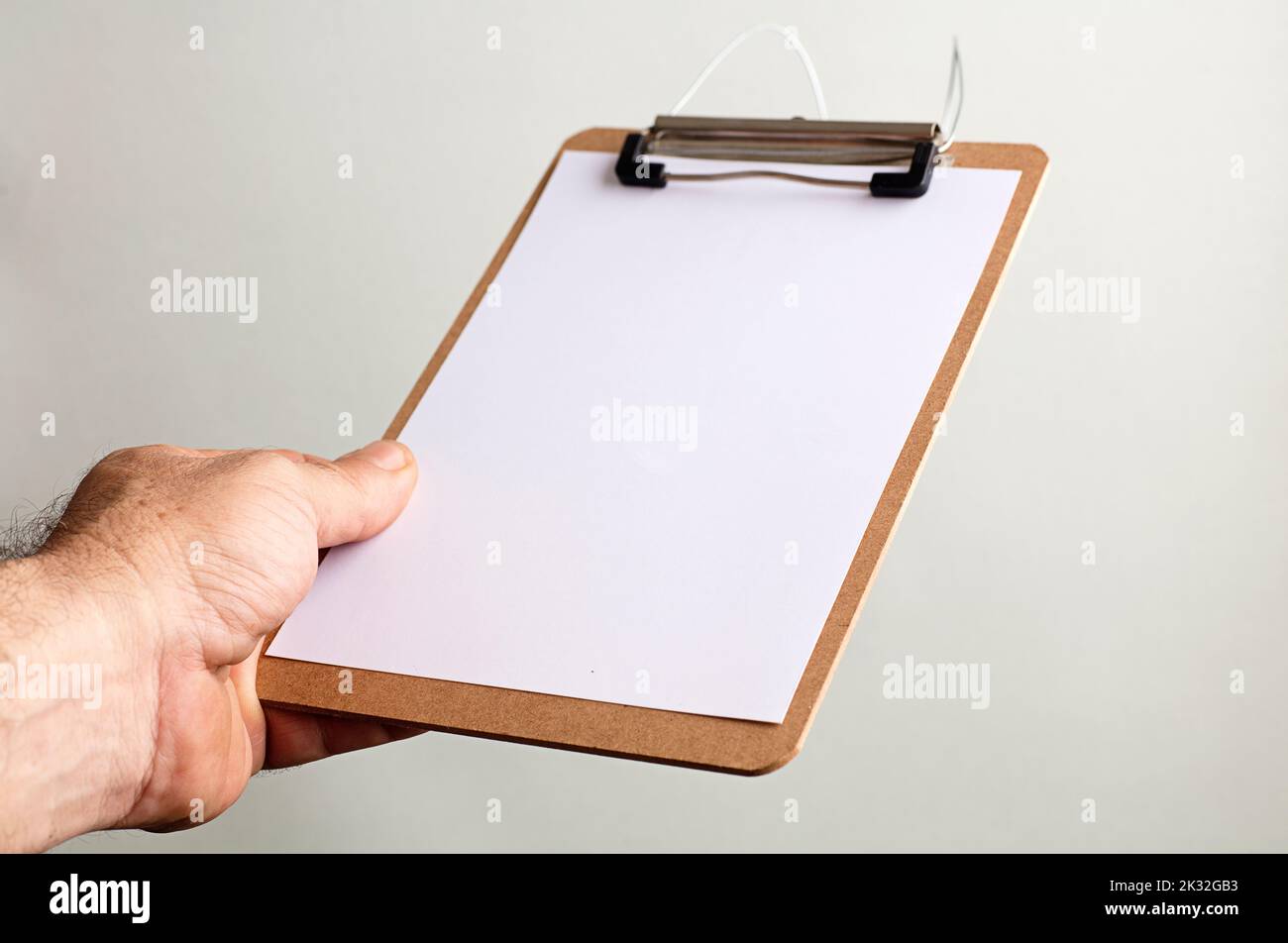 notepad with copy space in the hands of caucasian man, gray-green background Stock Photo