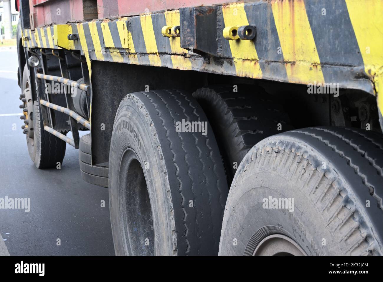 Colombo, Sri Lanka - August 05, 2022: Side View of tires of a Container truck or lorry on the road, center tire in focus Stock Photo