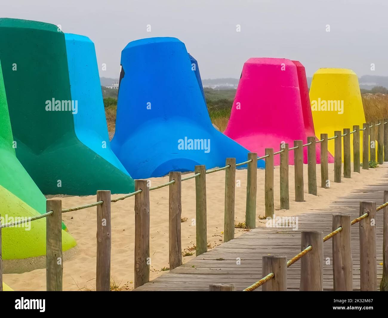 Colourful breakwaters at the sea for climate protection Stock Photo