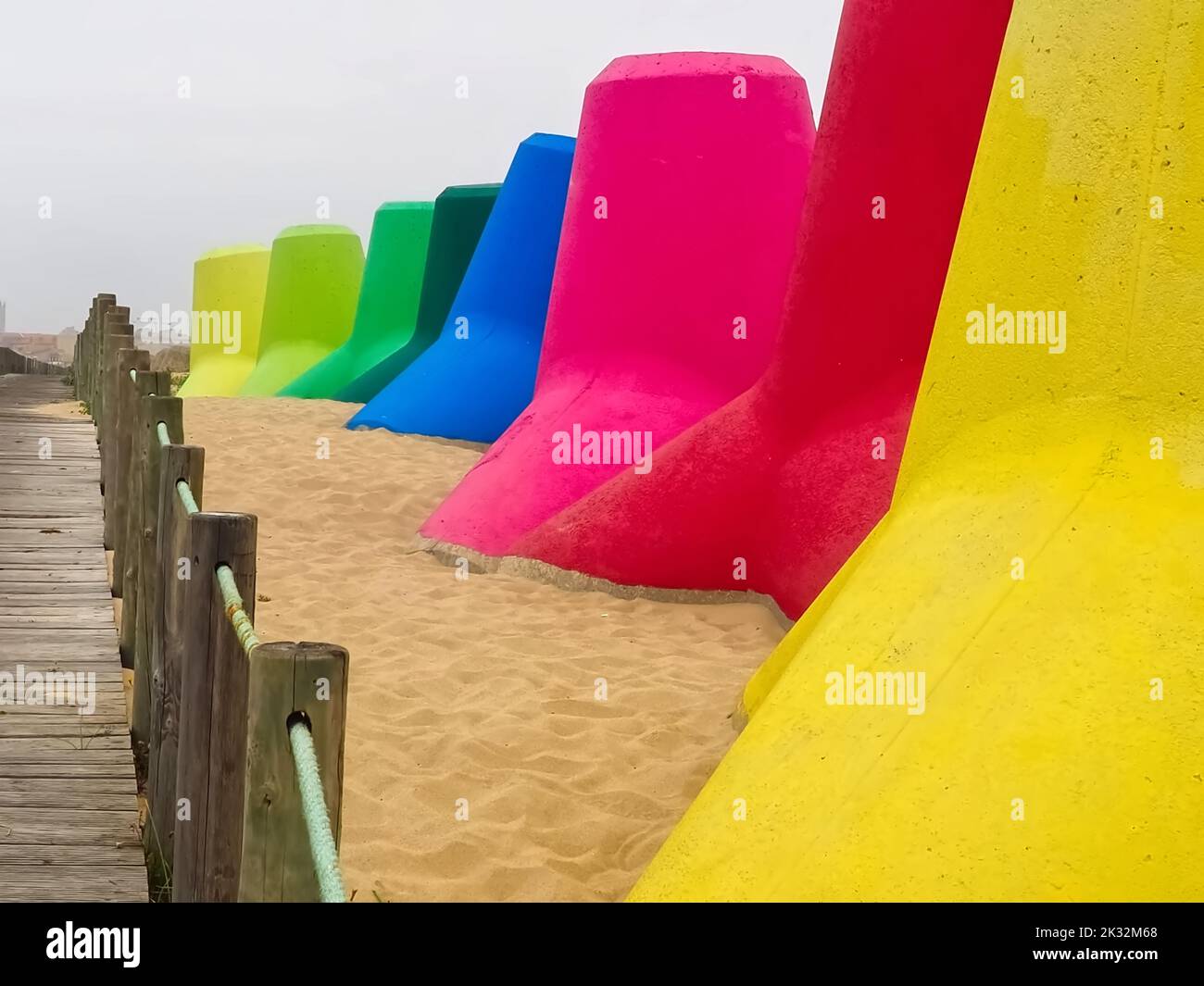 Colourful breakwaters at the sea for climate protection Stock Photo