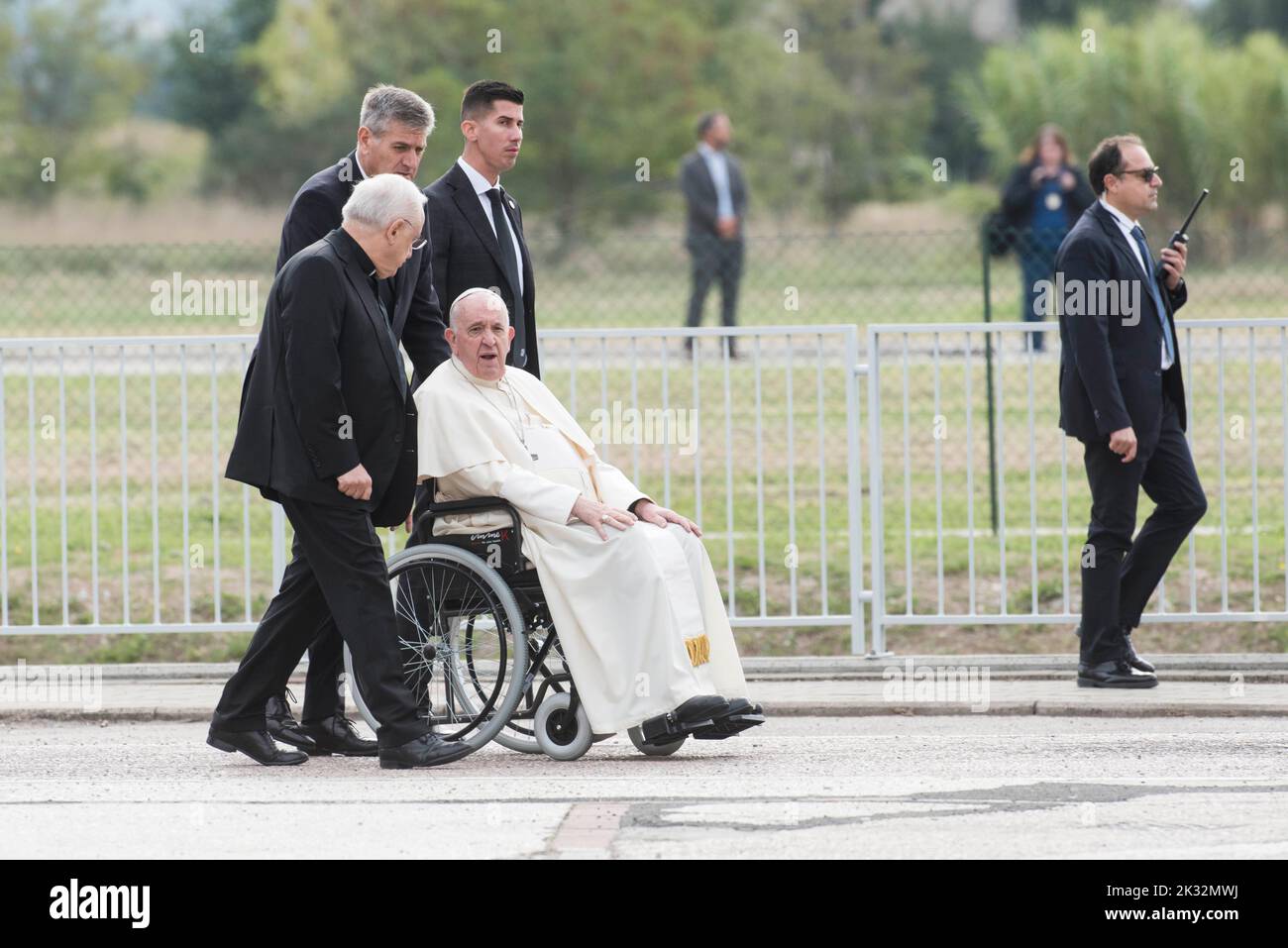 Italy, Assisi, Vatican, 22/09/24 Pope Francis, escorted by his aide Sandro Mariotti (Rear C), Vatican Security Chief, Gianluca Gauzzi Broccoletti (L) and Prefect of the Pontifical House, Monsignor Leonardo Sapienza (2ndL) arrives in a wheelchair after his helicopter landed in Assisi, central Italy, to attend the Economy of Francesco (EoF) event EoF is a process called for by the Pope to lay foundations for a new economy. Photograph by Andrea Colarieti /Catholic Press Photo. RESTRICTED TO EDITORIAL USE - NO MARKETING - NO ADVERTISING CAMPAIGNS Stock Photo