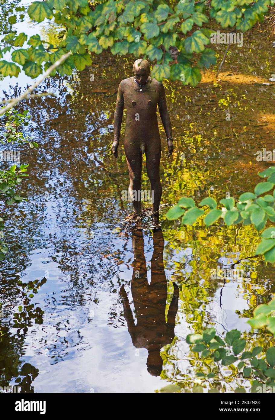 Stockbridge, Edinburgh Scotland, UK. 24th September 2022. Morning sunshine after a cloudy start to the day, temperature mid morning around 9 degrees rising to 13 degrees by lunchtime. Pictured: At Stockbridge, one of the six 'Six Times' Anthony Gormley statues cited in or near the water of Leith. Credit: Arch White/alamy live news. Stock Photo