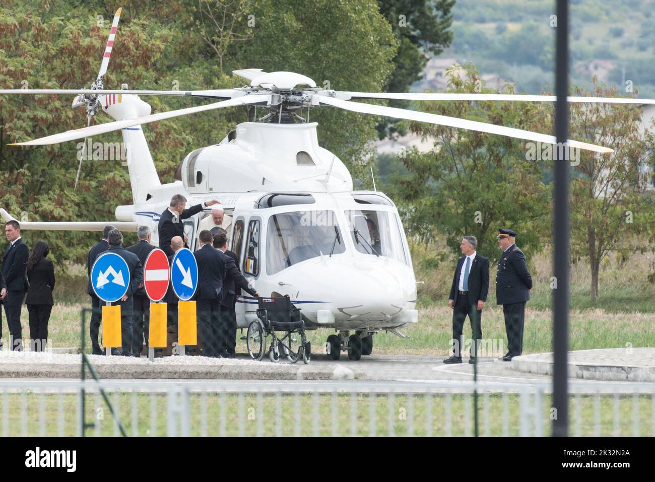 Italy, Assisi, Vatican, 22/09/24 Pope Francis, escorted by his aide Sandro Mariotti (Rear C), Vatican Security Chief, Gianluca Gauzzi Broccoletti (L) and Prefect of the Pontifical House, Monsignor Leonardo Sapienza (2ndL) arrives in a wheelchair after his helicopter landed in Assisi, central Italy, to attend the Economy of Francesco (EoF) event EoF is a process called for by the Pope to lay foundations for a new economy. Photograph by Andrea Colarieti /Catholic Press Photo. RESTRICTED TO EDITORIAL USE - NO MARKETING - NO ADVERTISING CAMPAIGNS Stock Photo
