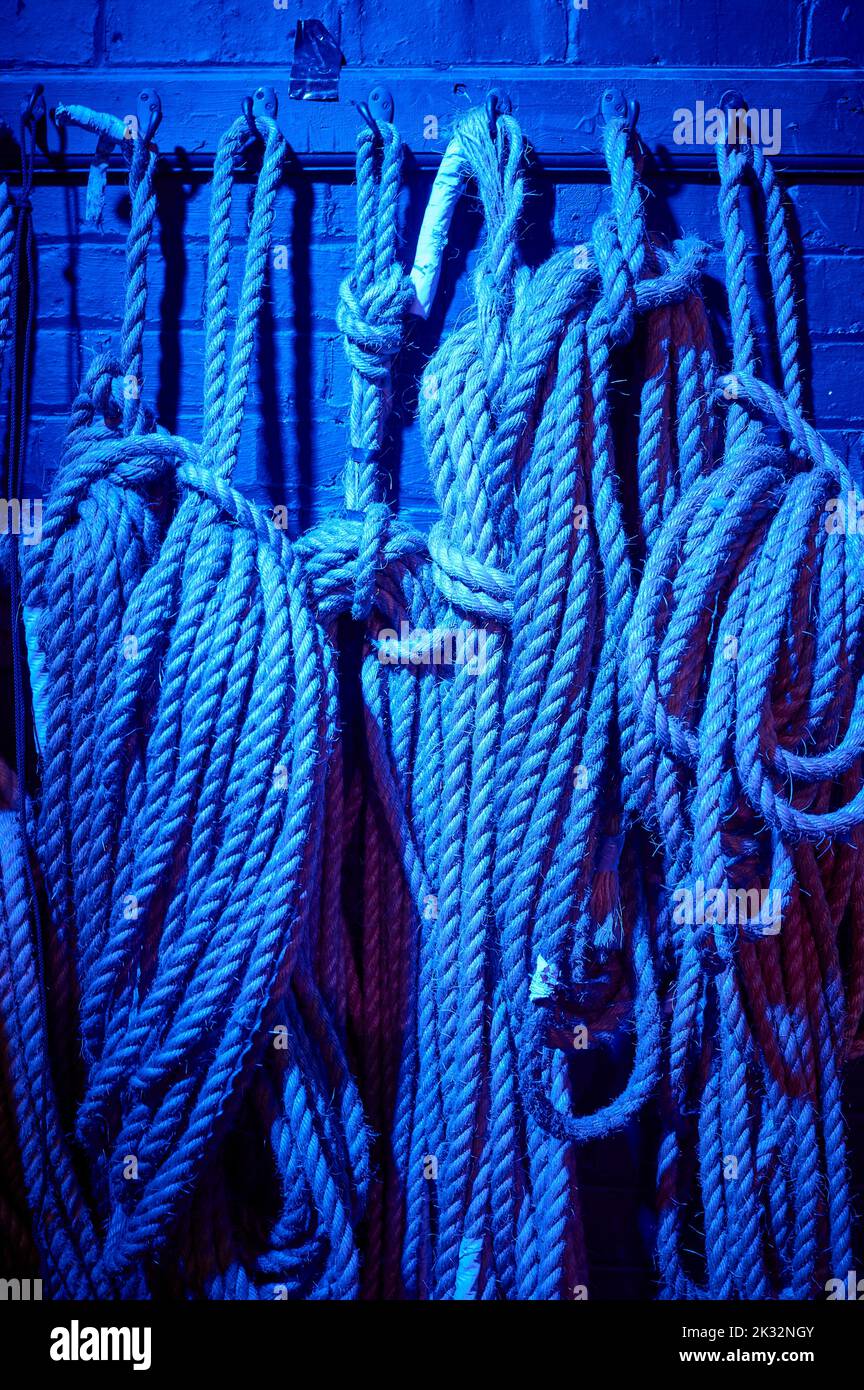 Ropes backstage at theatre in blue light Stock Photo