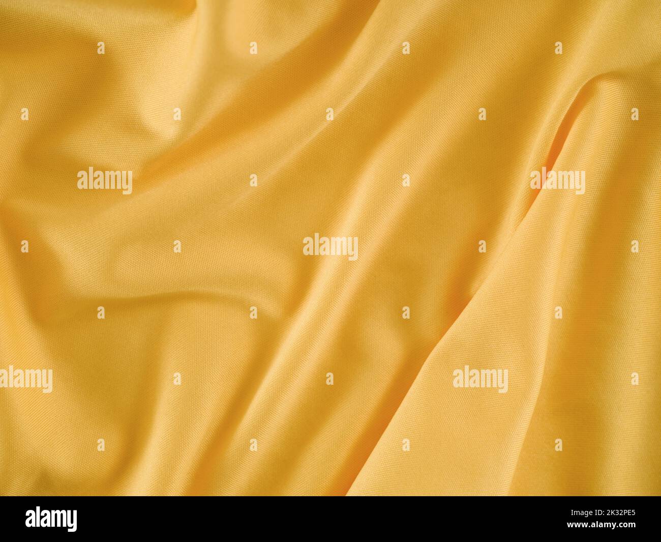 A crumpled gold fabric background. Close up. Stock Photo