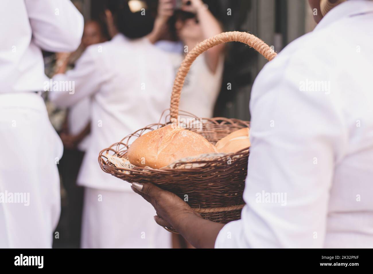 A closeup of People entering the church with food for the religious celebration Stock Photo