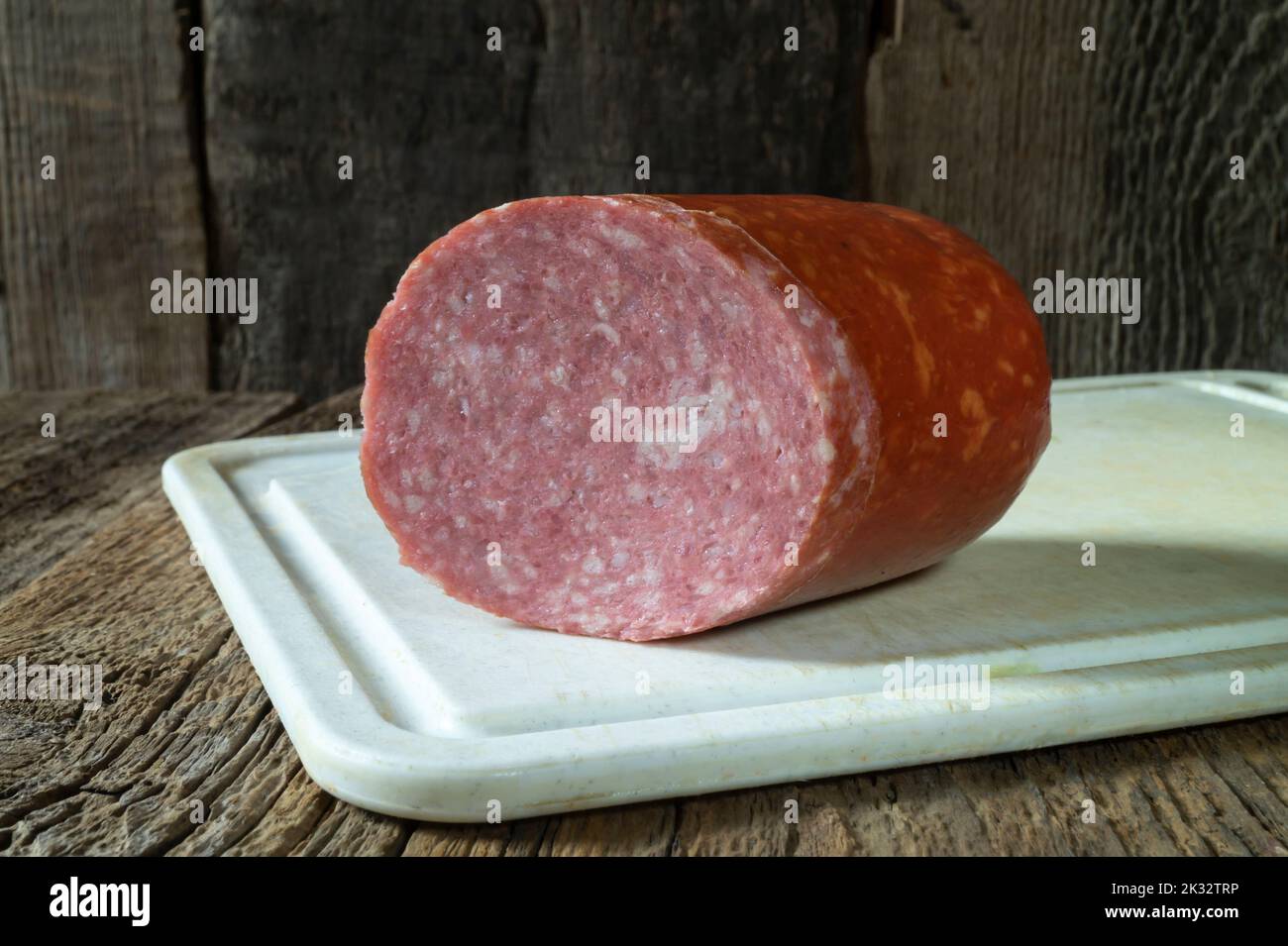 Food products on the background of old boards. Fresh sausage for breakfast. Horizontal close-up photo of food Stock Photo