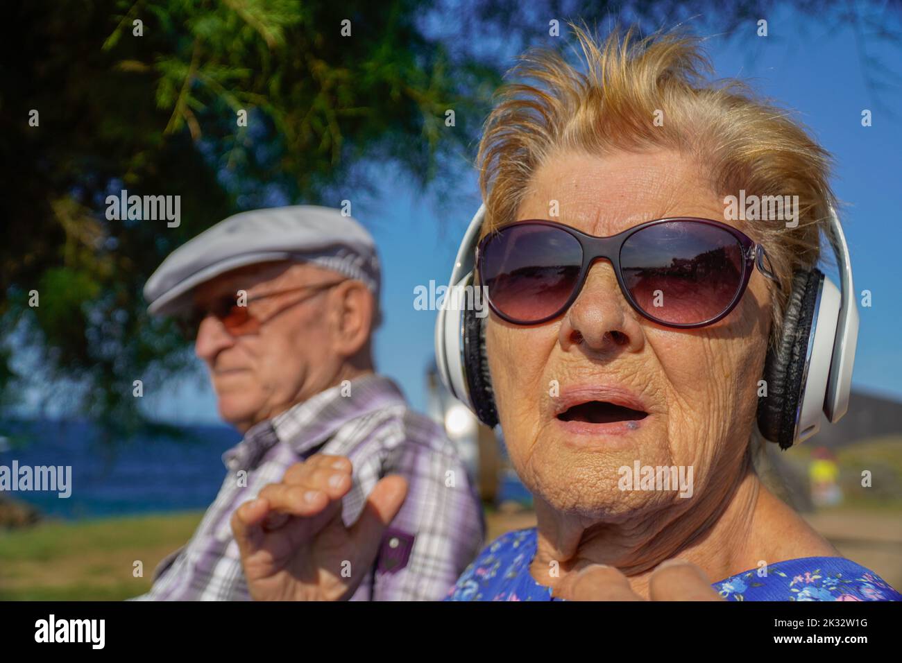 old people listen music in a park. Music therapy with elderly. Active ...