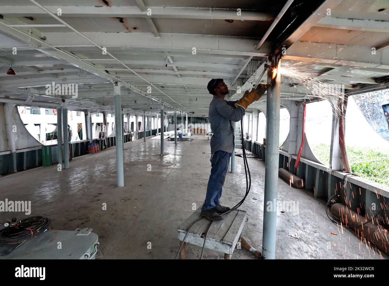 Dhaka, Bangladesh September 24, 2022 Worker cleaning up launch at