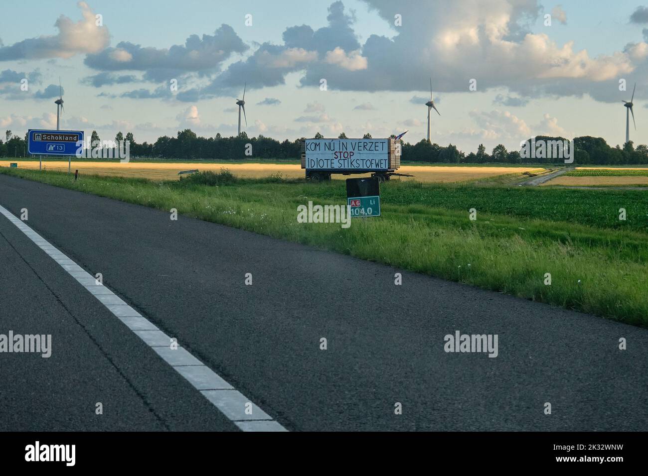 Banner next to highway with text 'Now resist, stop idiotic nitrogen law' Dutch farmers protest against the plans of the government forced shrinking of Stock Photo