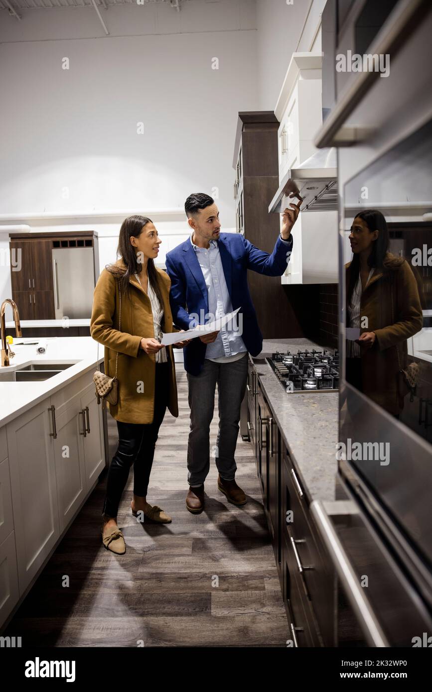 Couple looking at kitchen hood in showroom Stock Photo