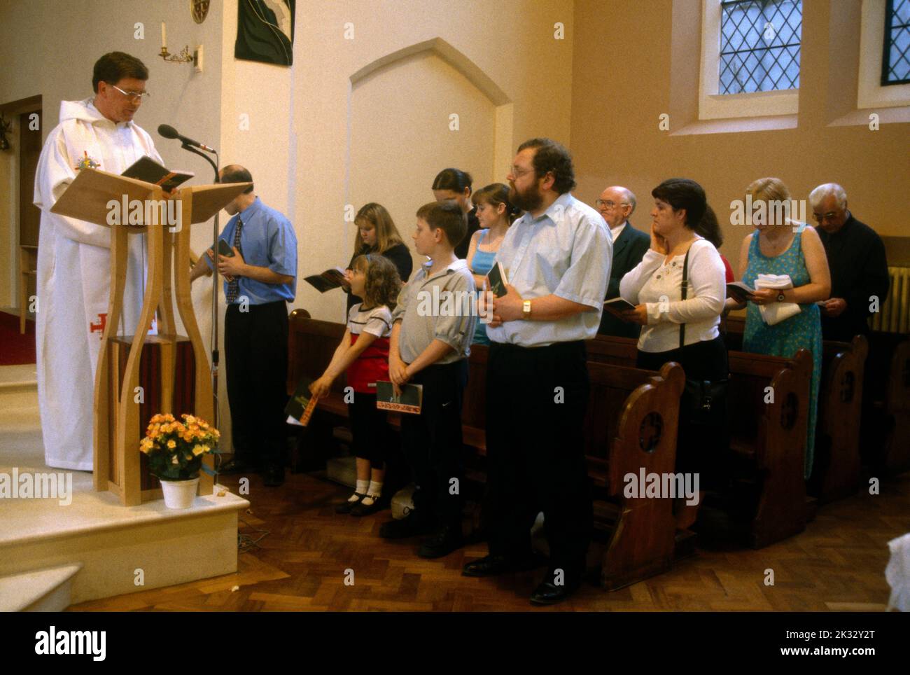 Priest Talking To Congregation At Baptism St Joseph's Catholic Church Roehampton London England Stock Photo