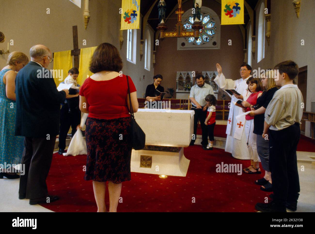 Baptism Priest Giving  Final Blessing At End Of Service St Joseph's Catholic Church Roehampton London England Stock Photo