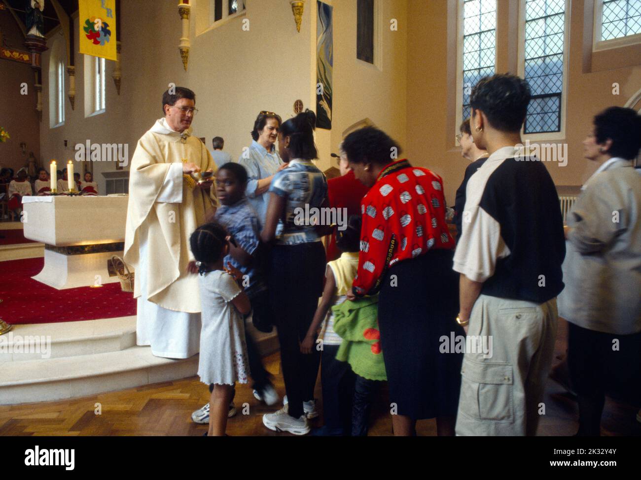 People Queuing for Communion at St Joseph's Church Roehampton London England Stock Photo