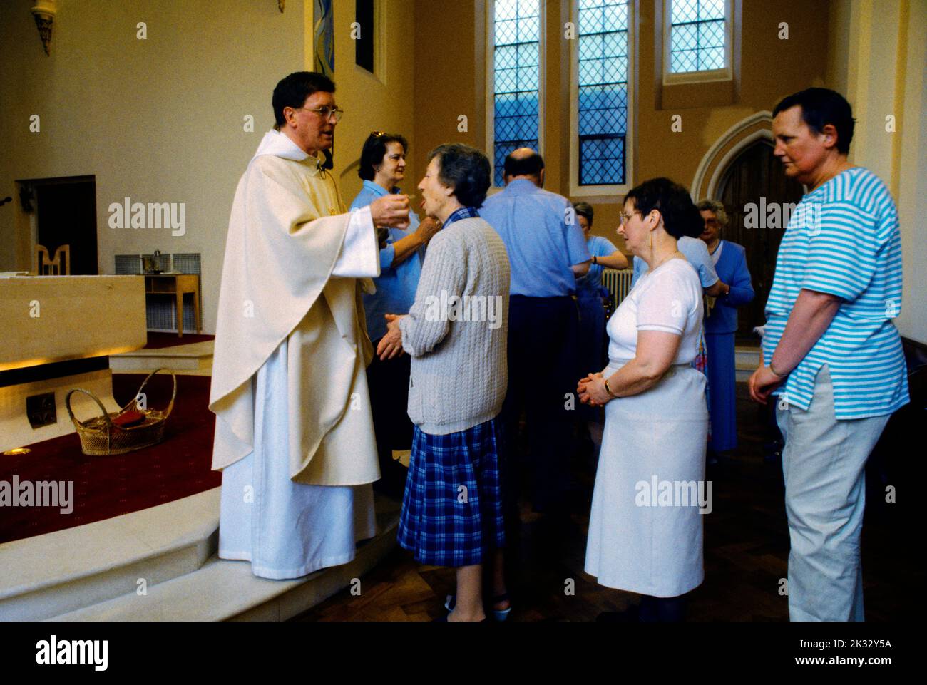 Woman Receiving Eucharist Wafer at Communion St Joseph's Church Roehampton London England Stock Photo