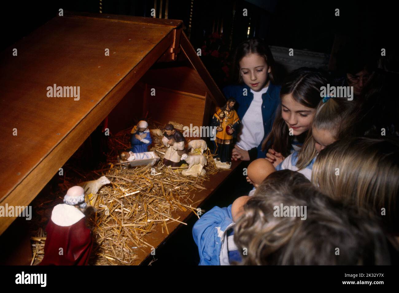 Children looking at Nativity Crib in Christ Church Epsom Surrey England Stock Photo