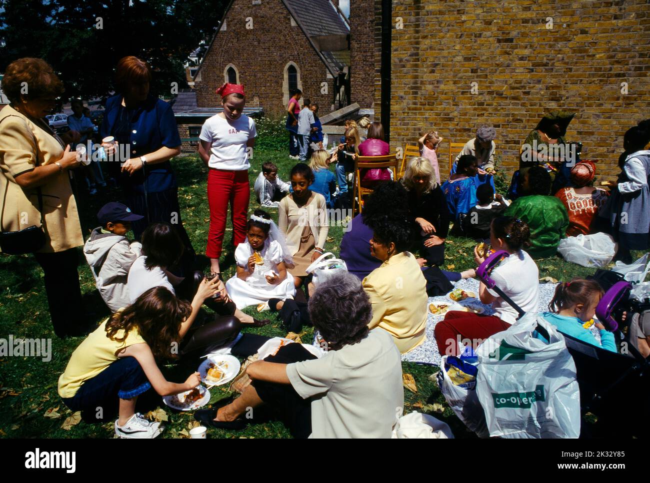Families at Barbeque After Sunday Mass Outside St Joseph's Catholic Church Roehampton London England Stock Photo