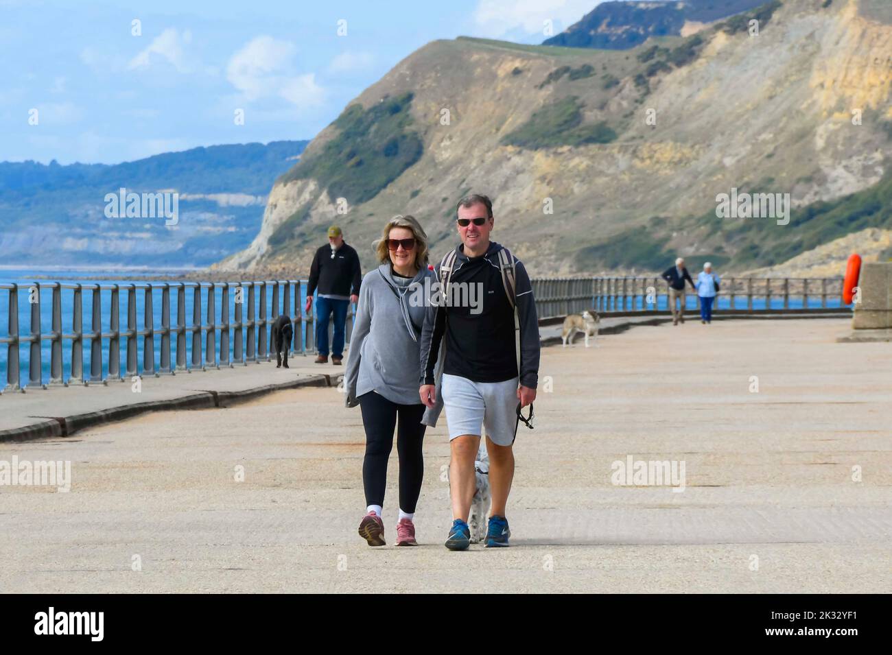 West Bay, Dorset, UK.  24th September 2022.  UK Weather.  The seaside resort of West Bay in Dorset is busy with visitors and locals enjoying the warm afternoon hazy autumn sunshine.  Picture Credit: Graham Hunt/Alamy Live News Stock Photo