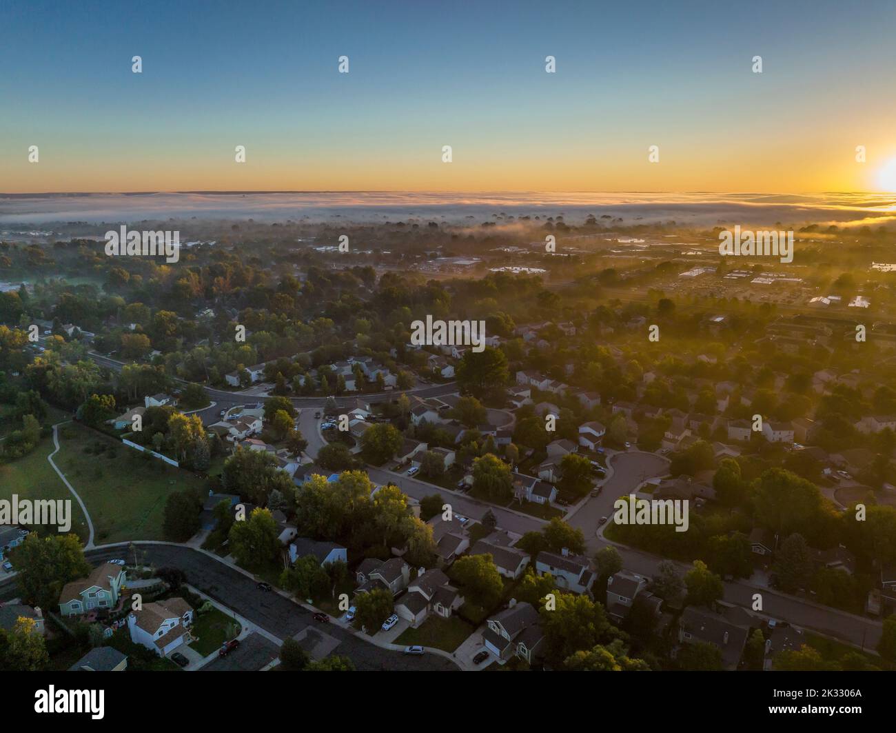 foggy fall sunrise over residential area of Fort Collins in northern Colorado, aerial view Stock Photo