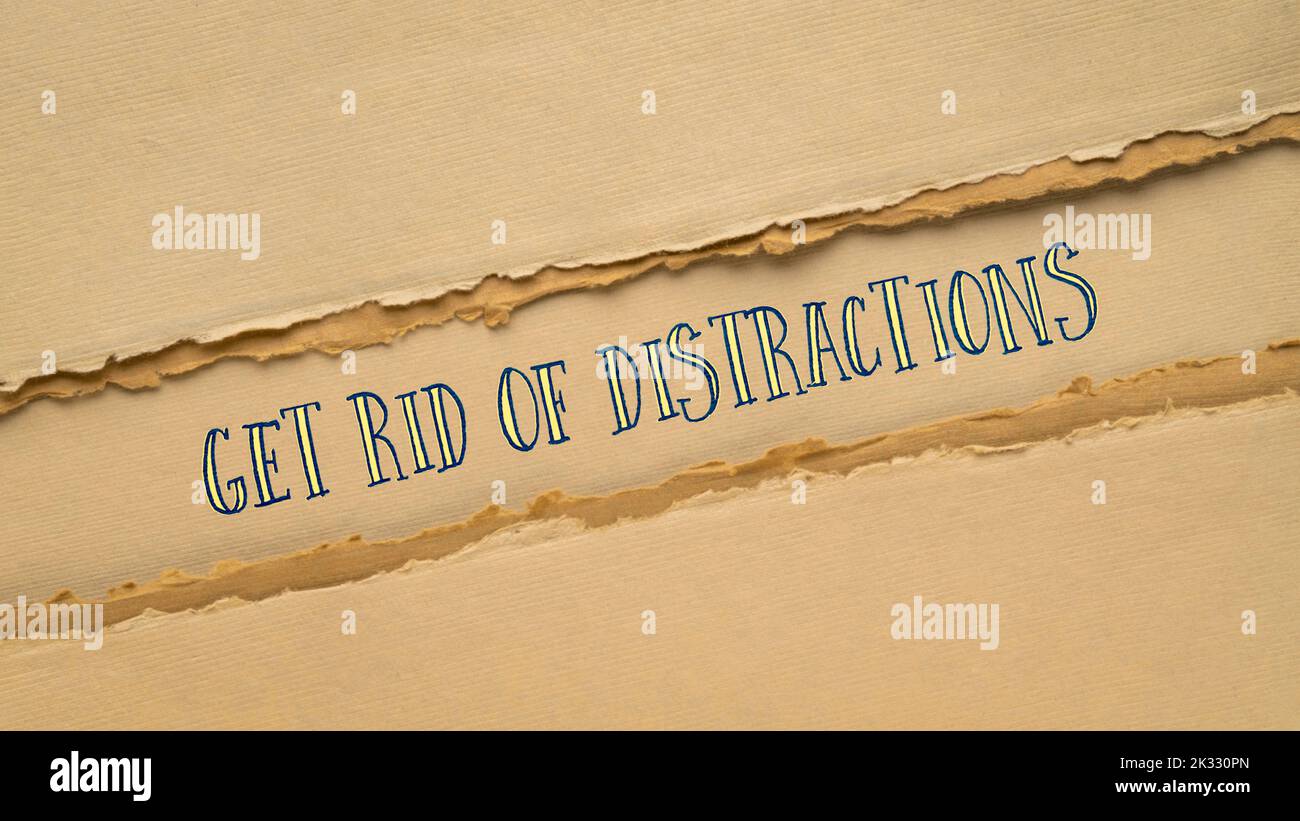 get rid of distractions motivational banner, text on handmade paper in earth tone, productivity concept Stock Photo