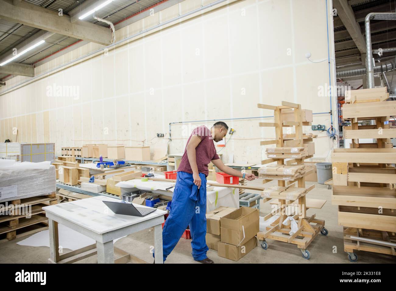 Worker checking building materials in distribution warehouse Stock