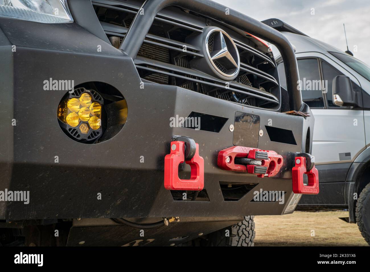 Loveland, CO, USA - August 26, 2022:  Grille and front bumper of Mercedes Sprinter camper van withLED off-road headlights, winch and shackles. Stock Photo