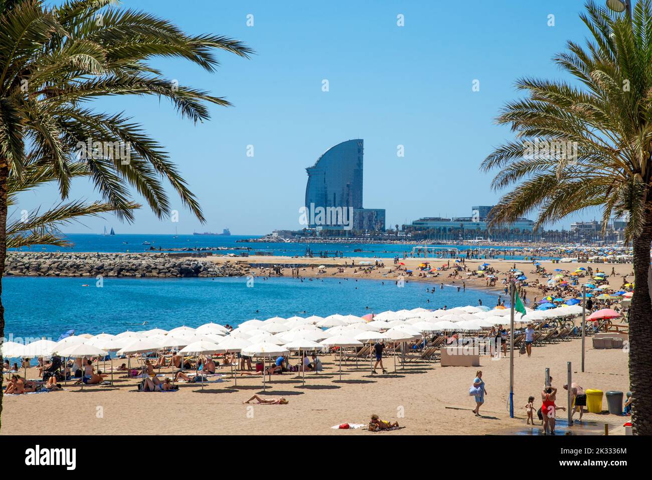 Somorrostro beach in Barcelona city and distant W hotel tower, Spain Stock Photo