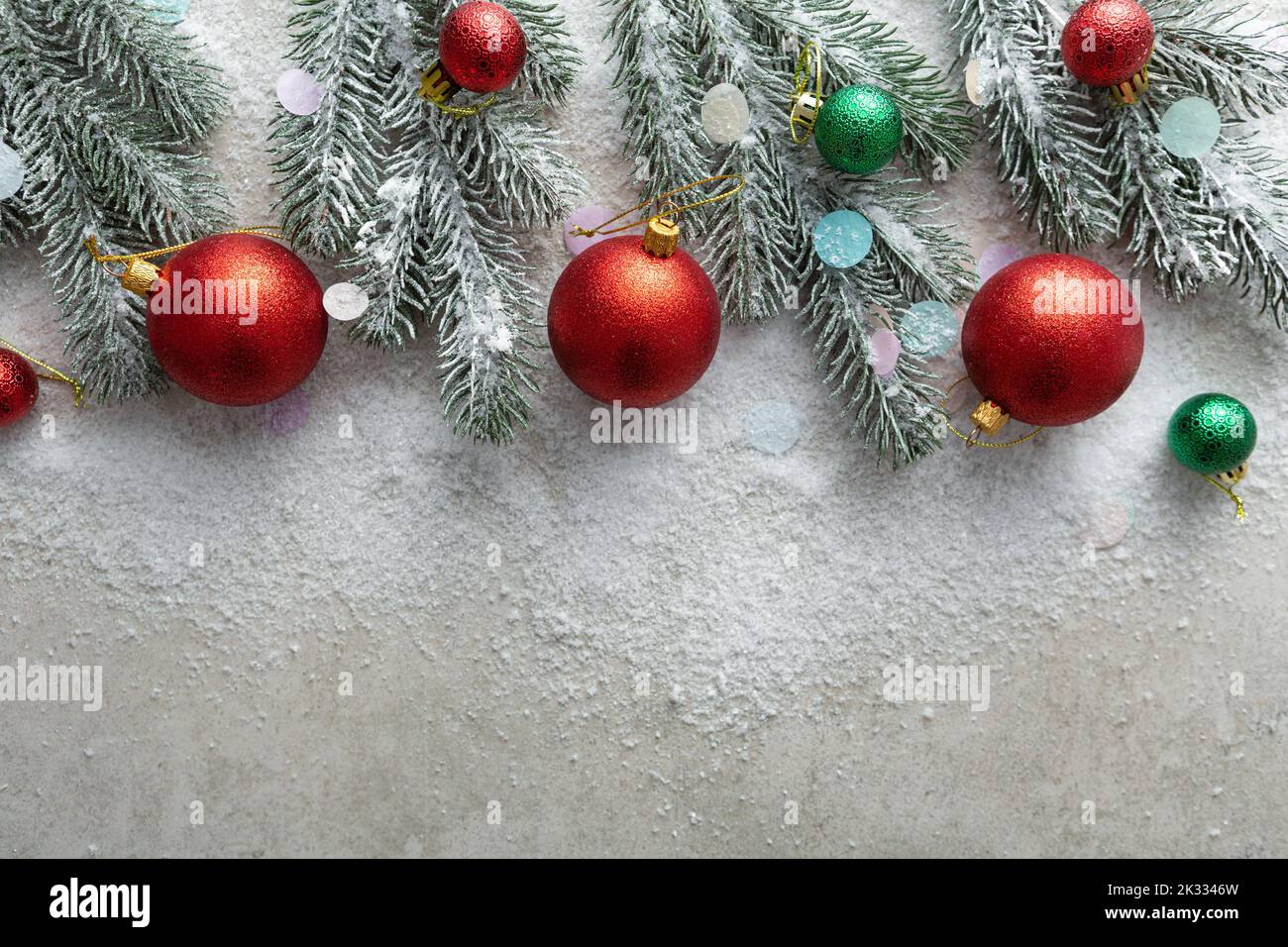 Christmas concept copy space background with branches and decorations top view snow and red balls Stock Photo
