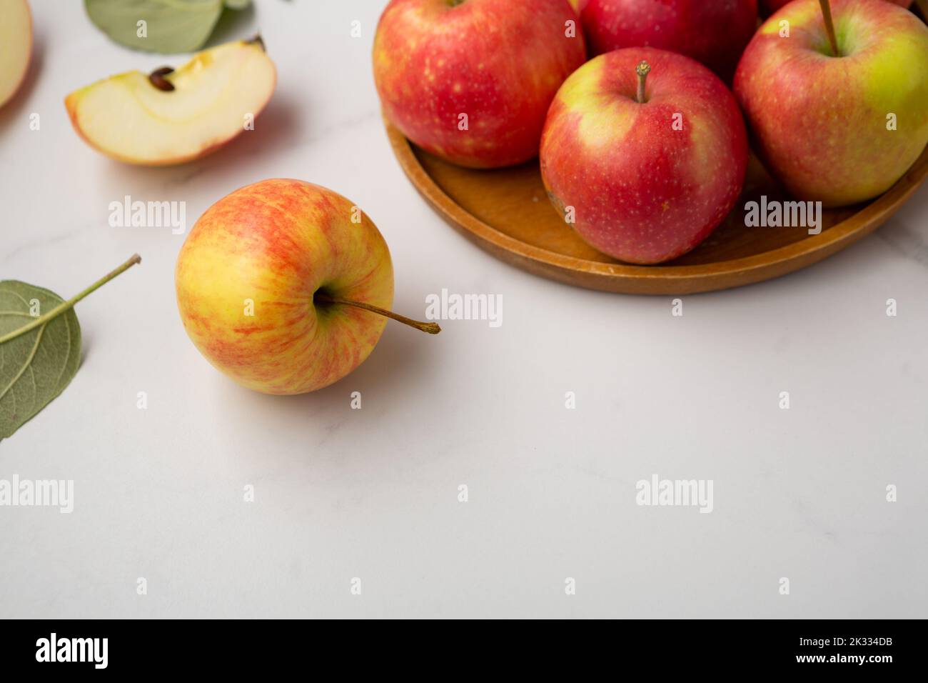 Close up of red yellow apples on wooden plate fruits food copy space Stock Photo