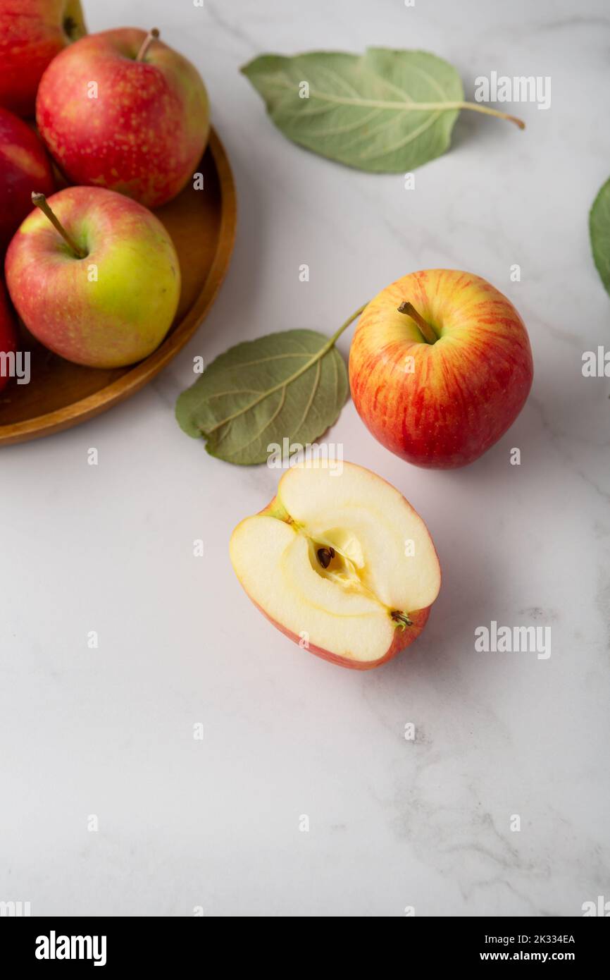 Close up of red yellow apples whole and sliced on plate fruits food copy space Stock Photo