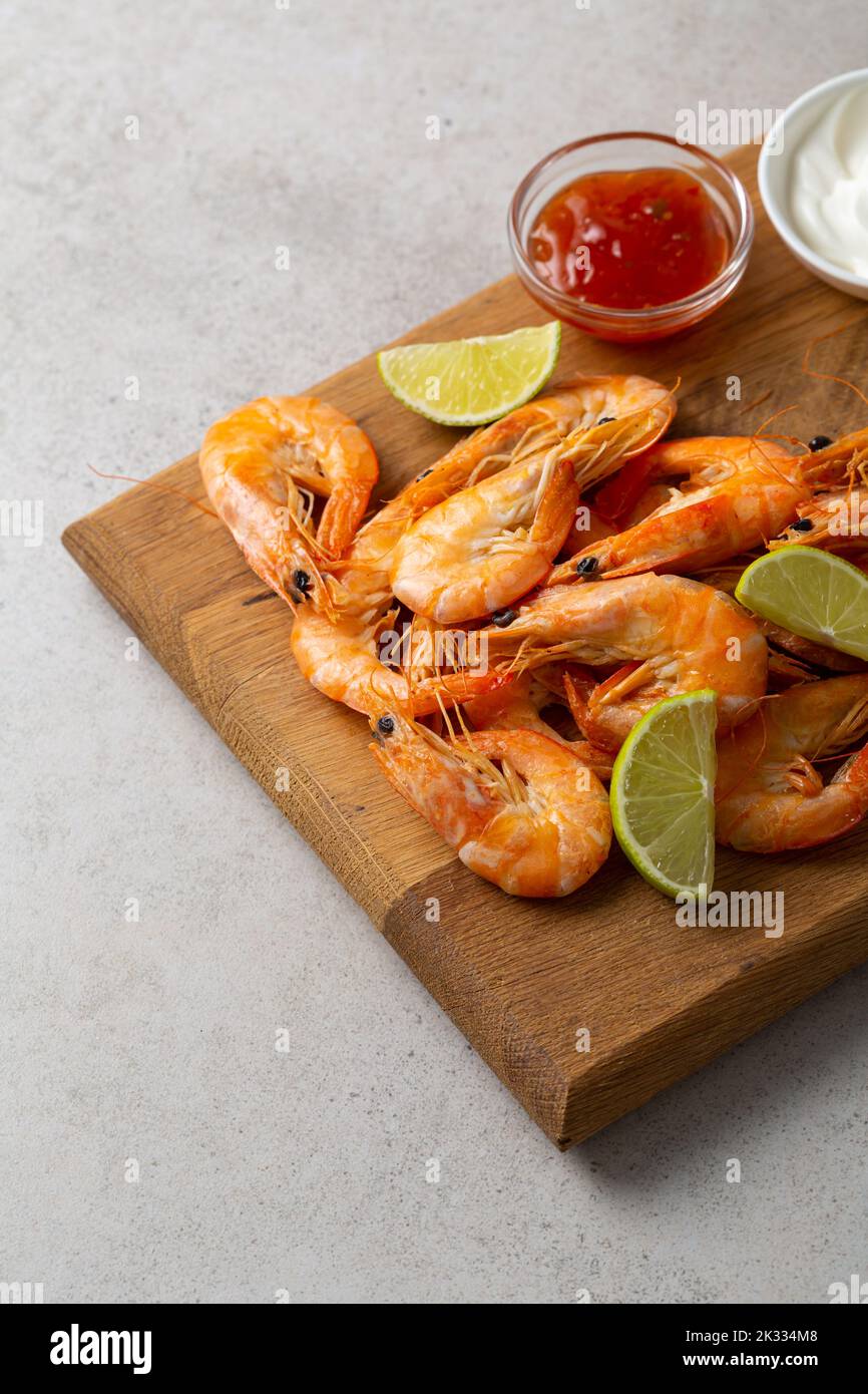 Seafood shrimps on wooden boards lime sauces dip snack food Stock Photo