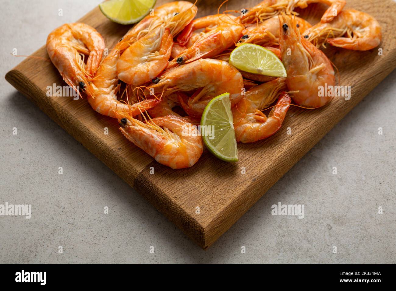 Seafood shrimps on wooden boards lime close up snack food Stock Photo