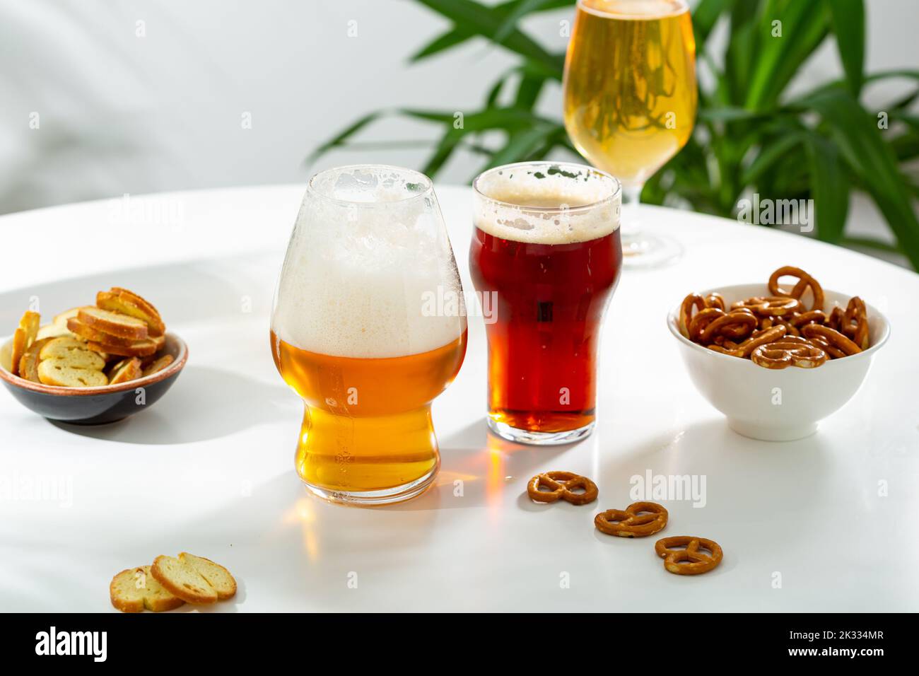 Three glasses with beer light craft dark and snacks Stock Photo
