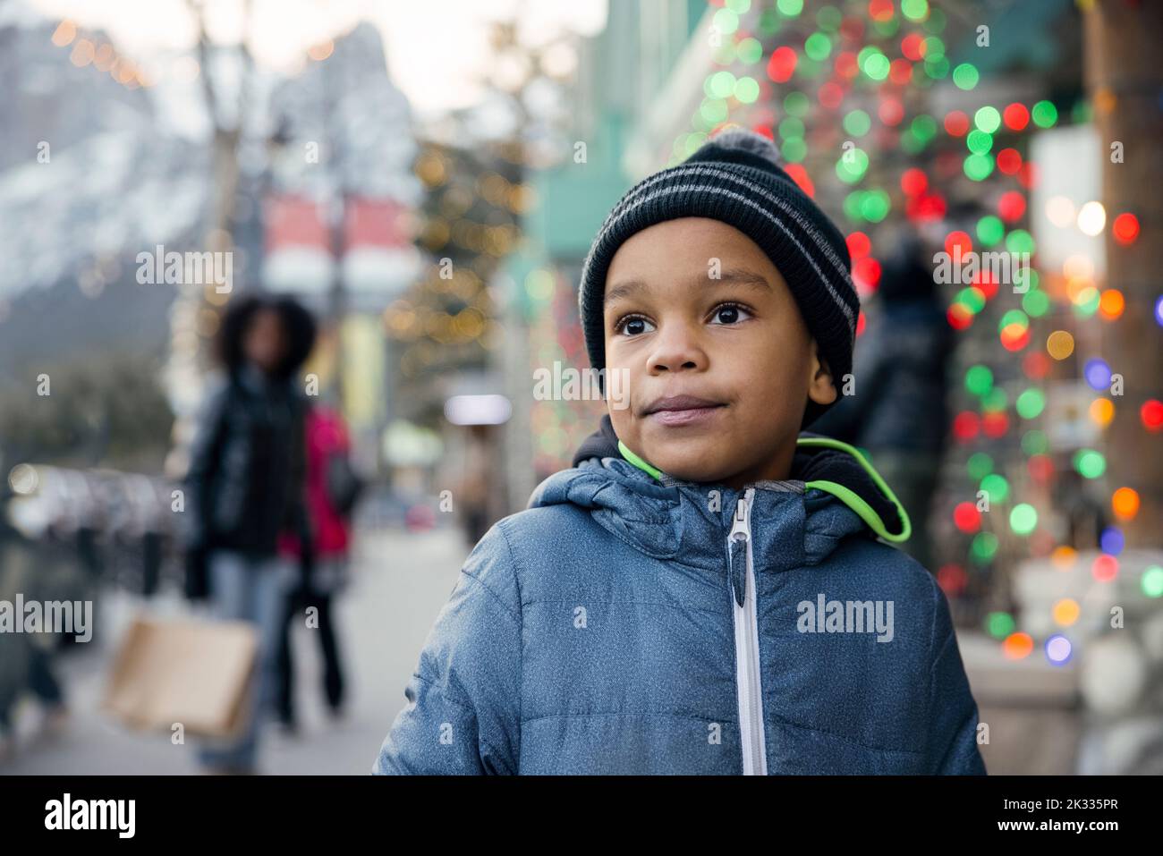 Child standing on front of Christmas lights Stock Photo Alamy