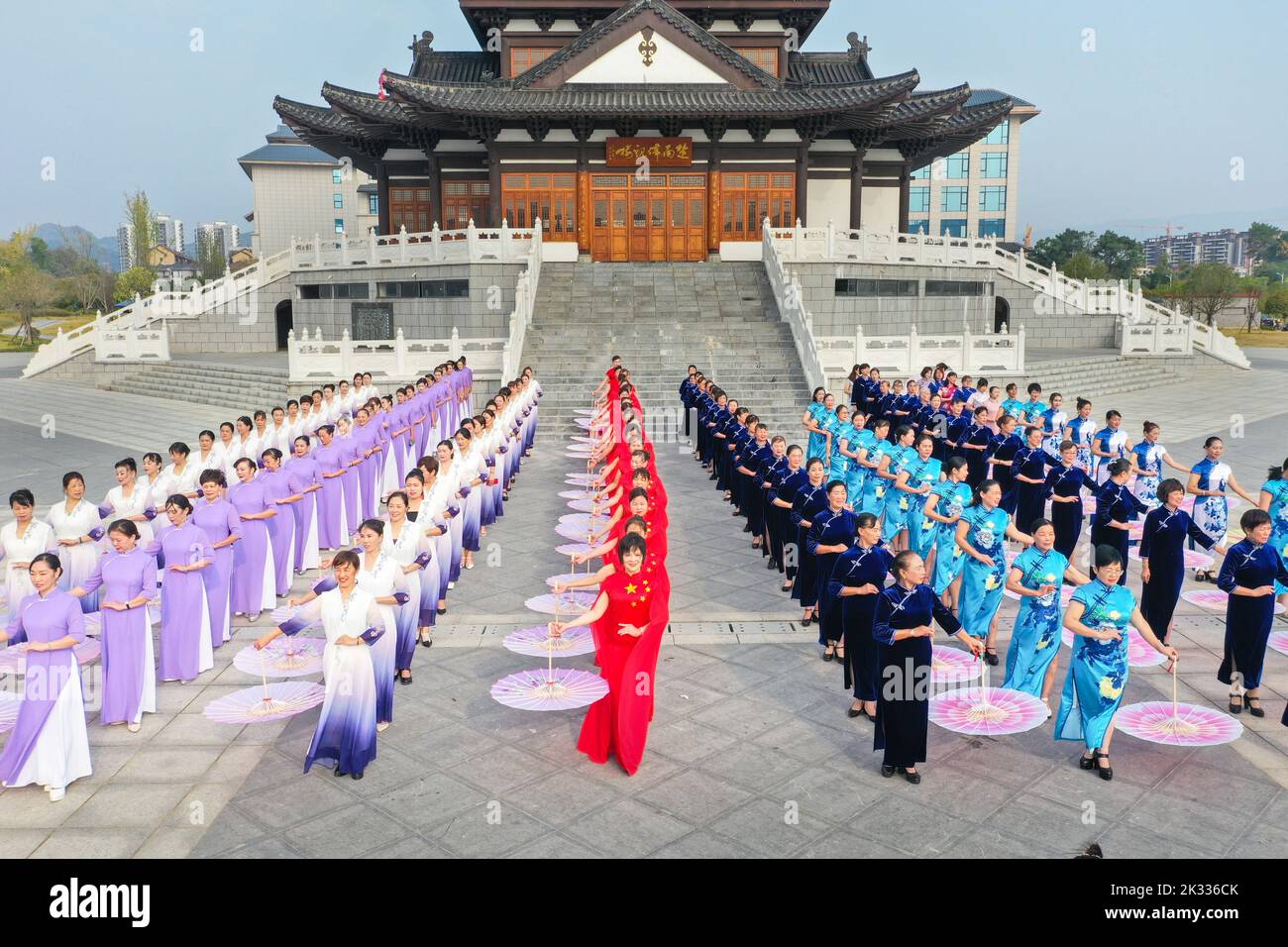 GUILIN, CHINA - SEPTEMBER 24, 2022 - Cheongsam lovers walk on the runway in front of ancient buildings in Guilin, South China's Guangxi Zhuang autonom Stock Photo