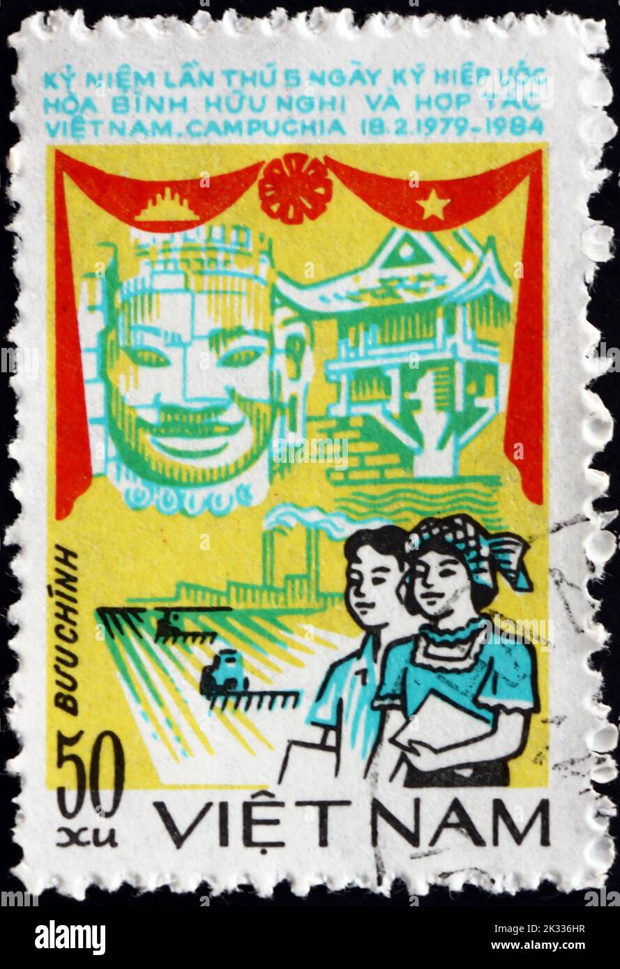 VIETNAM - CIRCA 1984: a stamp printed in Vietnam shows people, pagoda and statue, Vietnam-Cambodia friendship agreement, 5th anniversary, circa 1984 Stock Photo