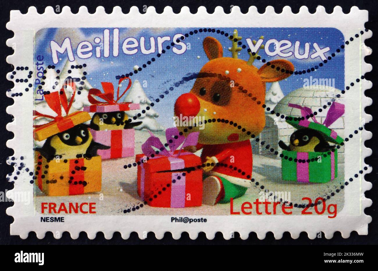 FRANCE - CIRCA 2006: a stamp printed in France shows Reindeer with Gift Boxes and Three Penguins, Holiday Greeting, circa 2006 Stock Photo