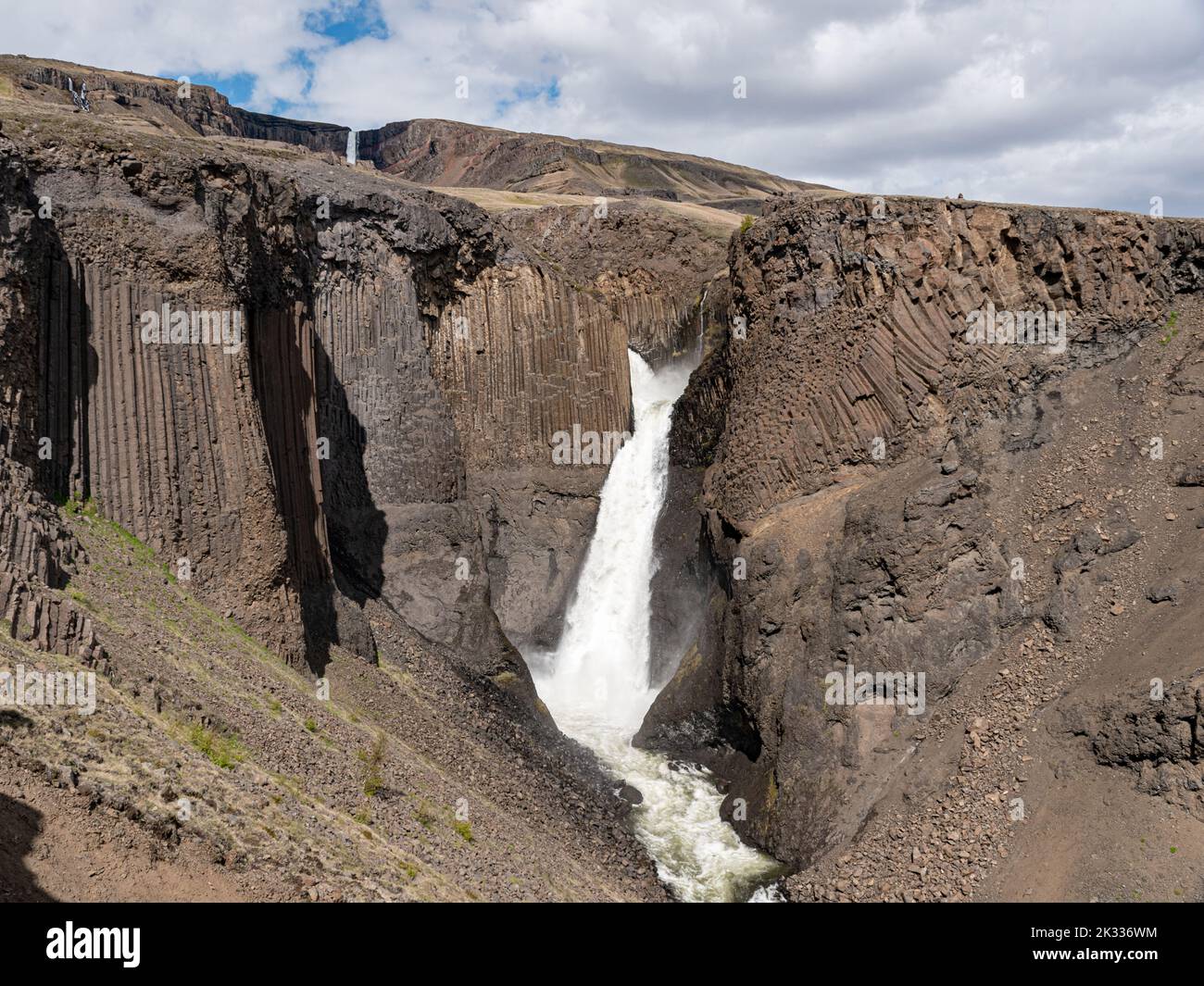 Waterfall Litlanesfoss surrounded by basalt columns in eastern Iceland Stock Photo