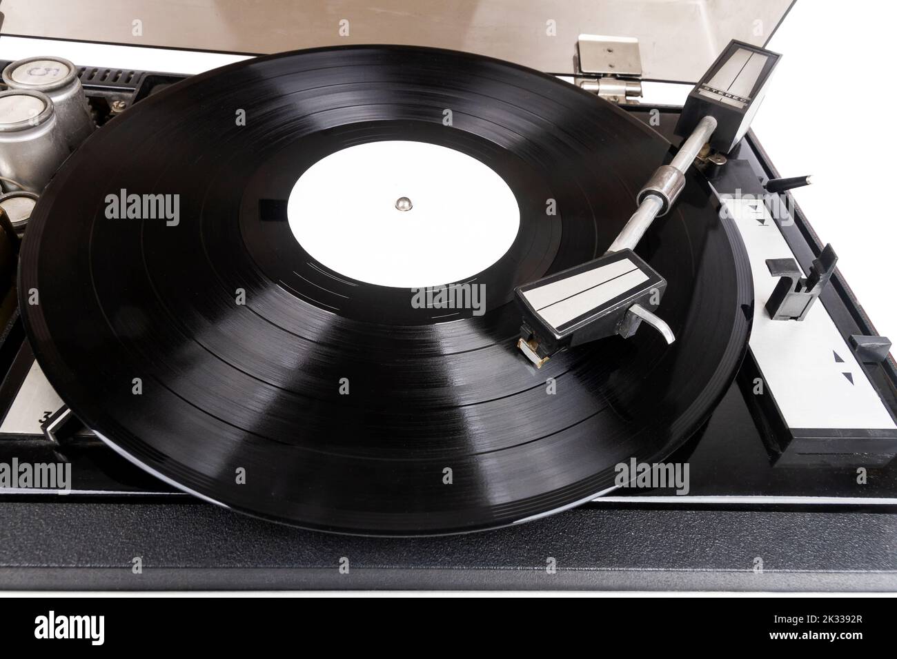 Vintage turntable record player with black vinyl isolated on white