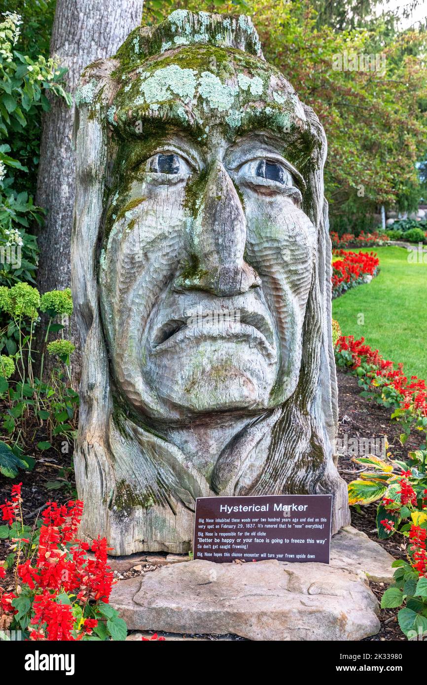 Humorous wooden carved statue to chief Big Nose, a native American Indian living near to Lake Geneva, Wisconsin county, America, USA Stock Photo