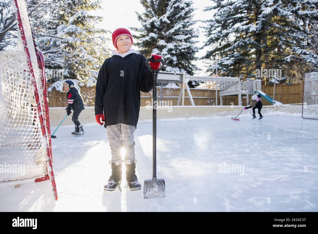 Portrait boy with shovel on backyard ice hockey rink Stock Photo Alamy