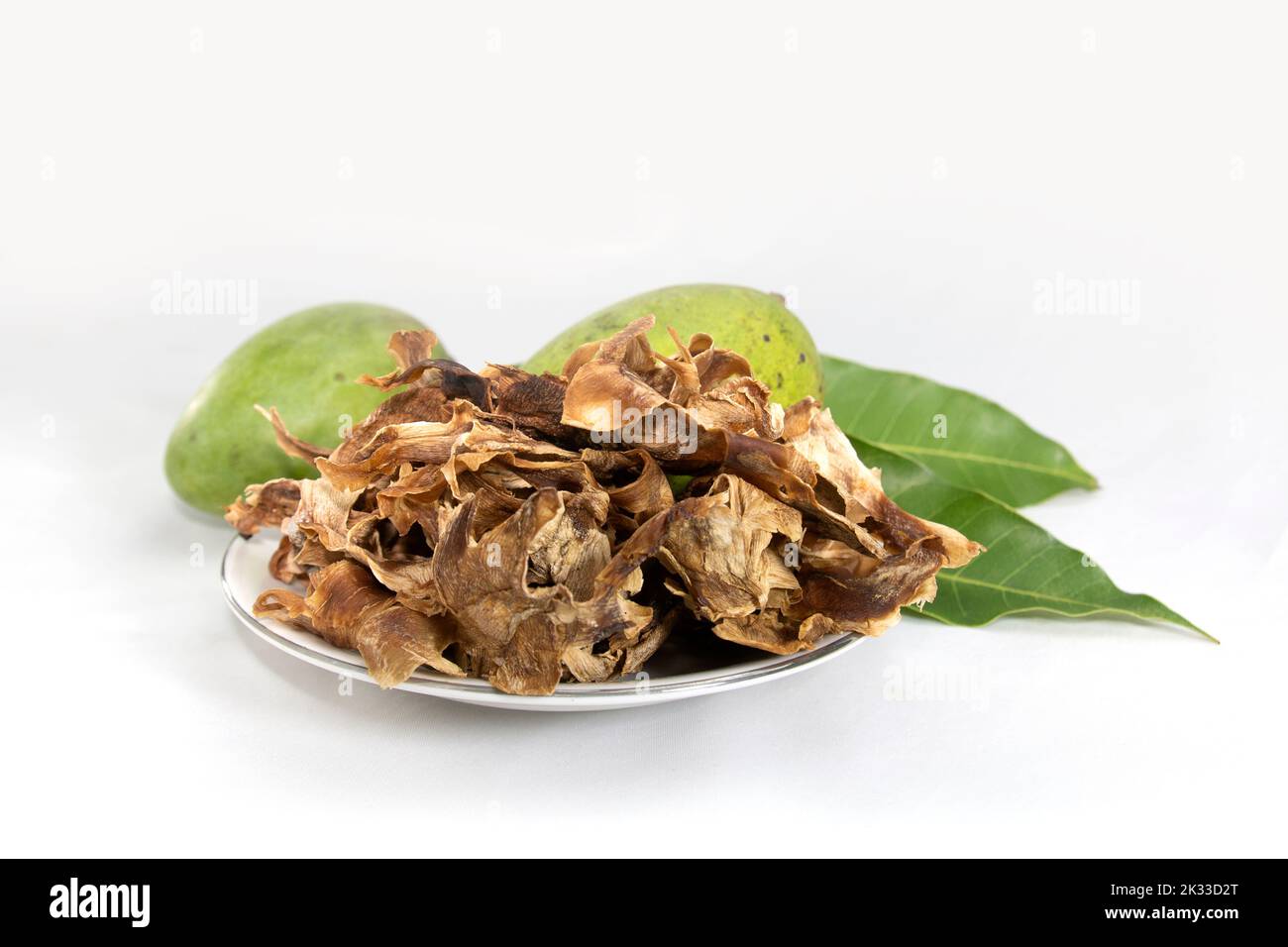 Dried mango slices and mangoes with leaves. traditional sun dry food