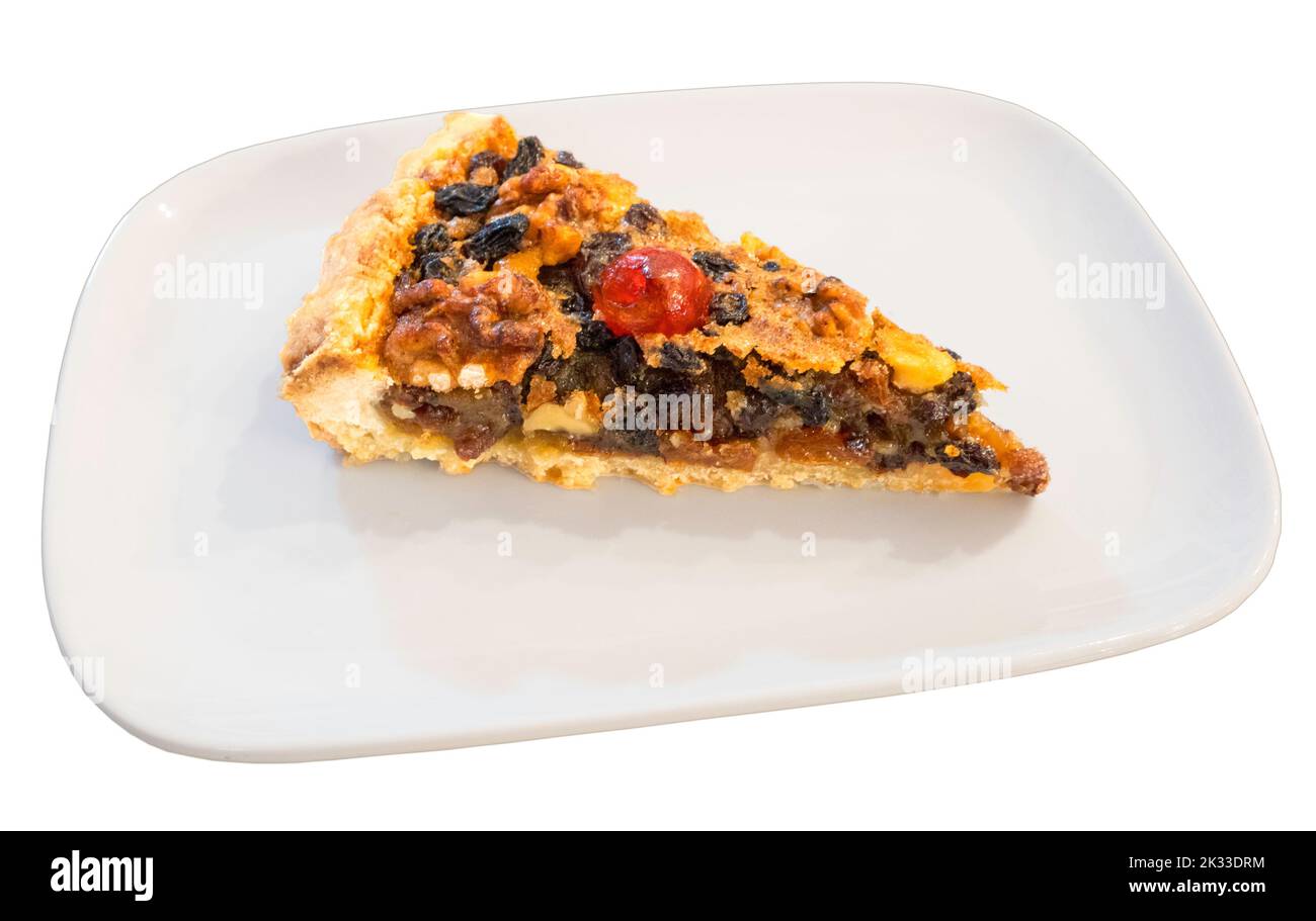 A slice of Ecclefechan Tart on a white plate isolated on a white background. Stock Photo