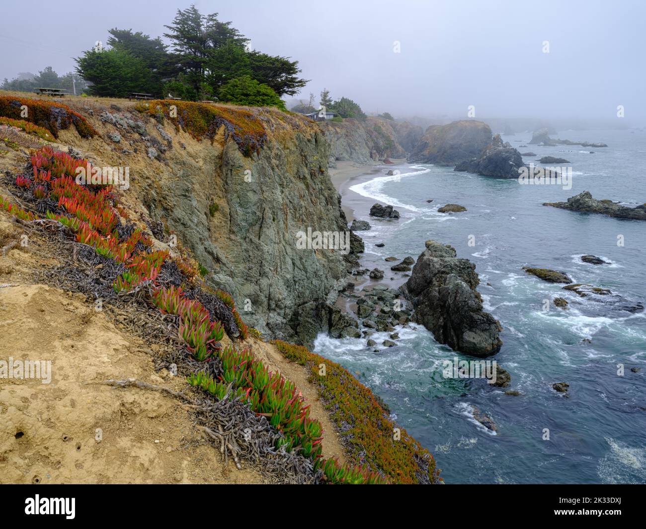 An atmospheric cliffside house with a private beach in rocky surroundings on the west coast of California Stock Photo