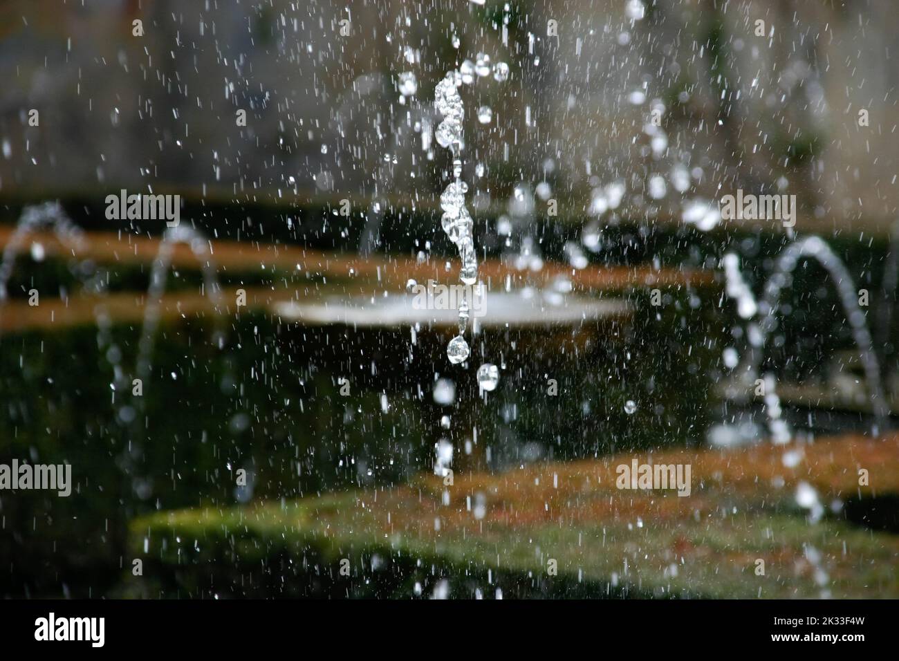 The splashing fountain water in motion in the air Stock Photo