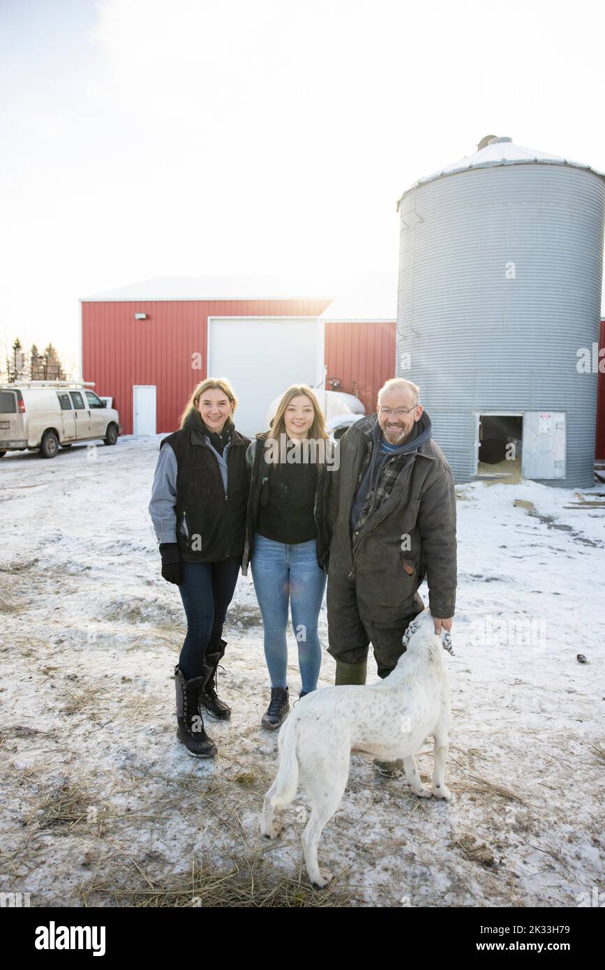 Family of farmers and dog on farmyard Stock Photo Alamy